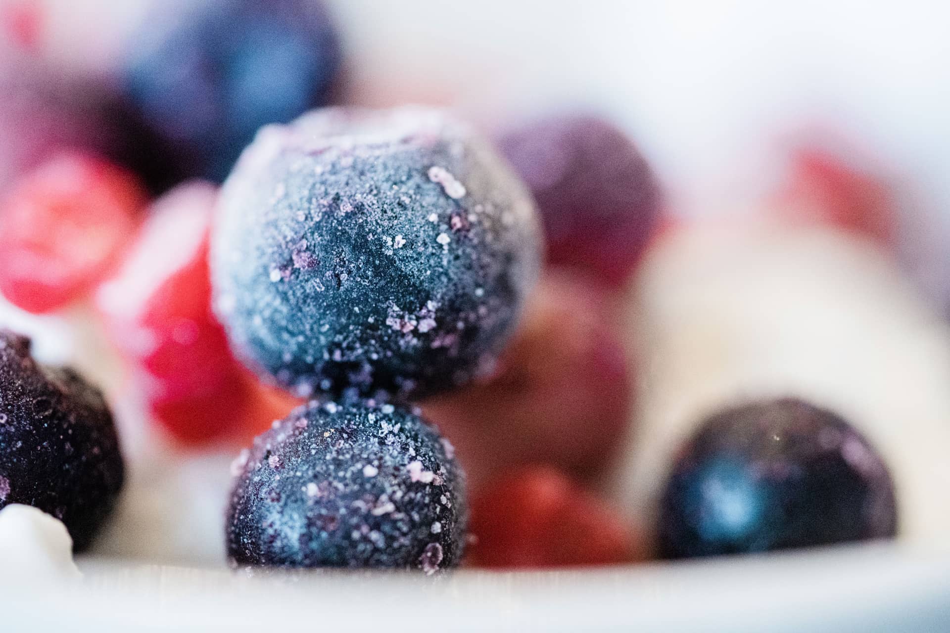 Frozen blueberries and mixed fruit covered in frost