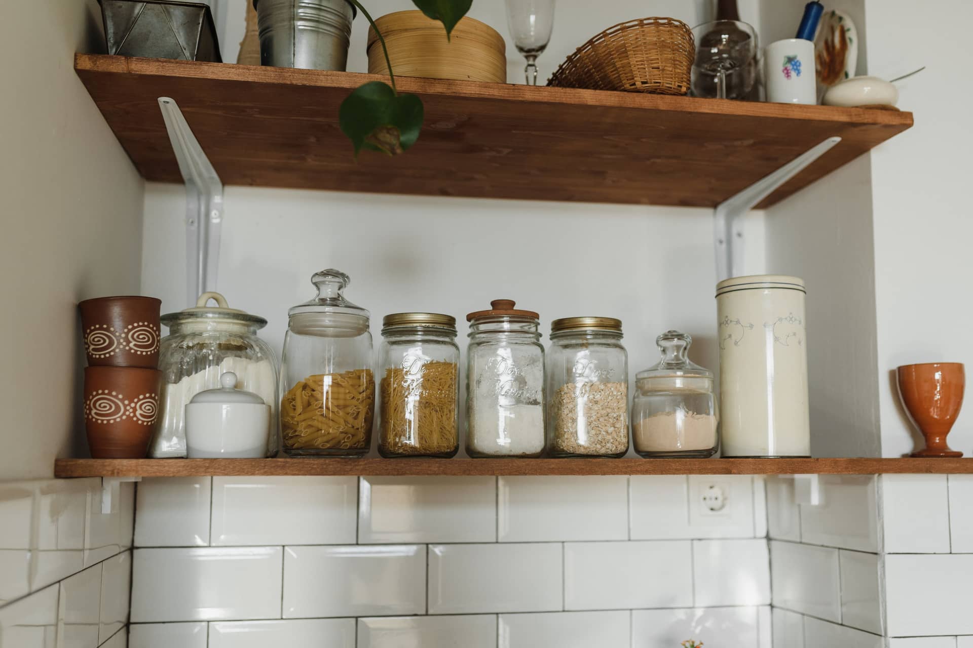 Kitchen shelves lined with glass jars and containers