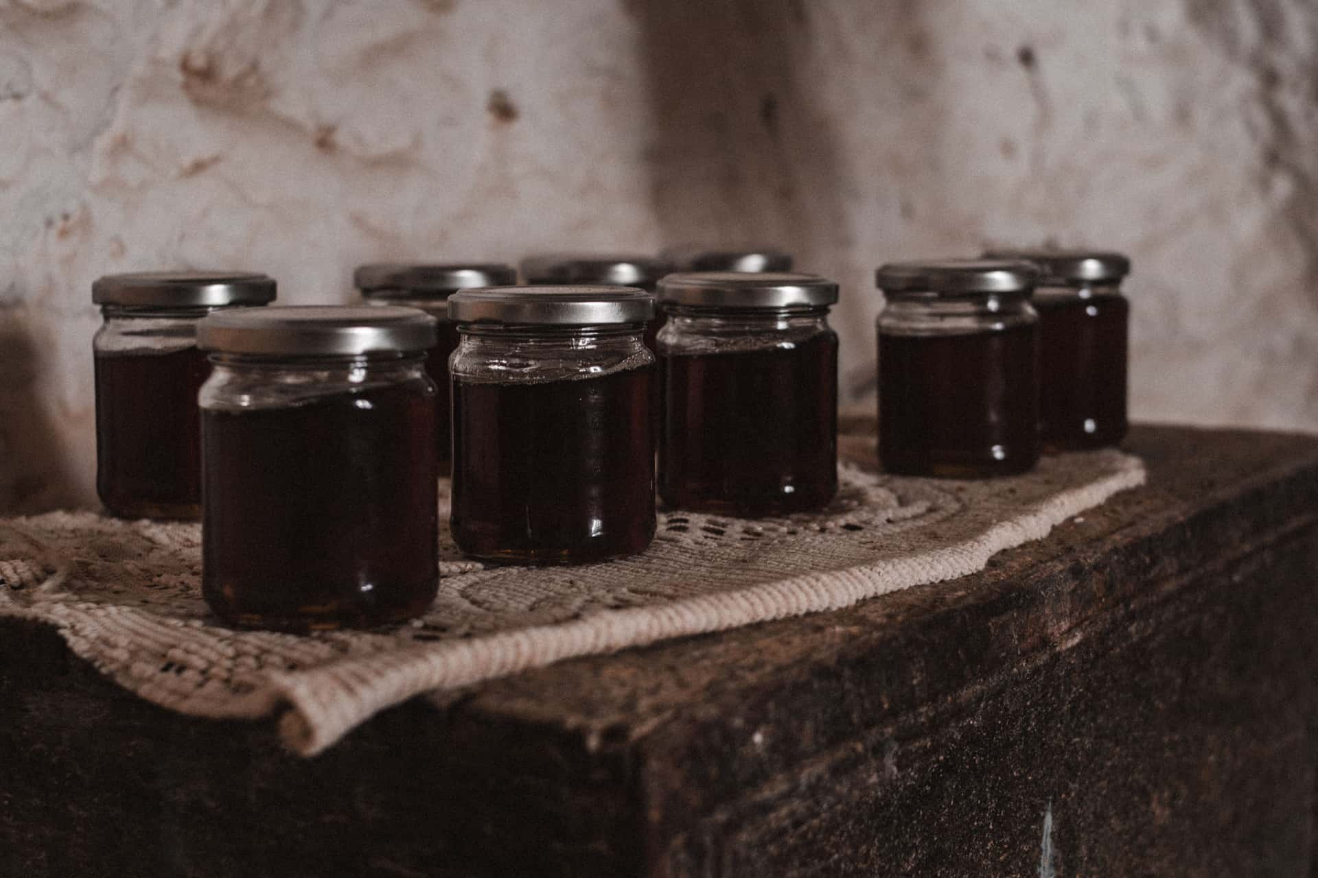 Glass jars with lids on a wooden surface