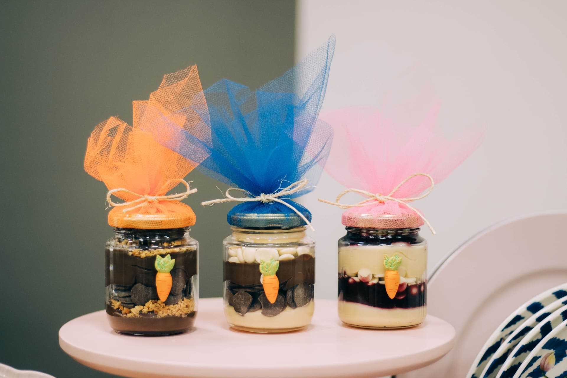 Jars, a jar lifter and a recipe book arranged as a gift on a dark table