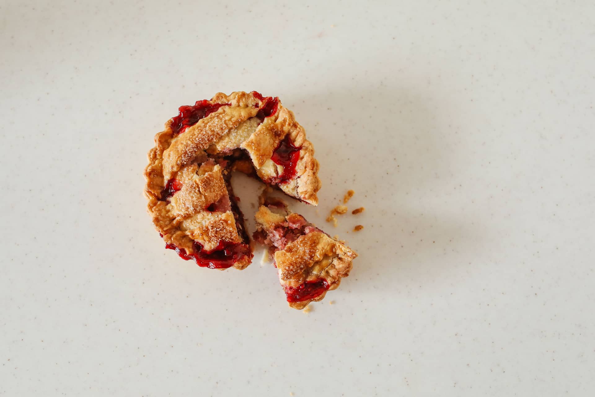 A rustic cherry pie with slices cut from it