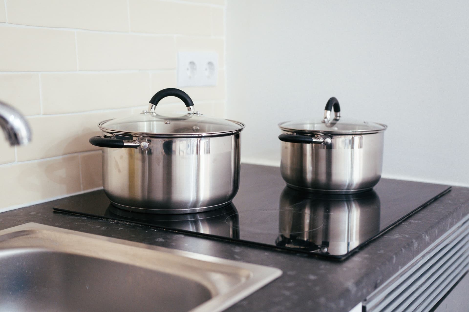 Two pots on a glass ceramic electric cooktop