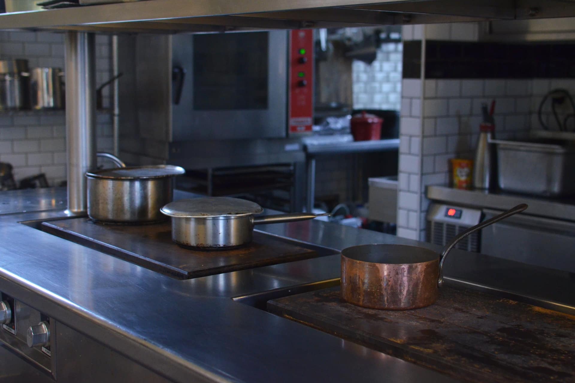 Stainless steel pots side by side on a kitchen counter