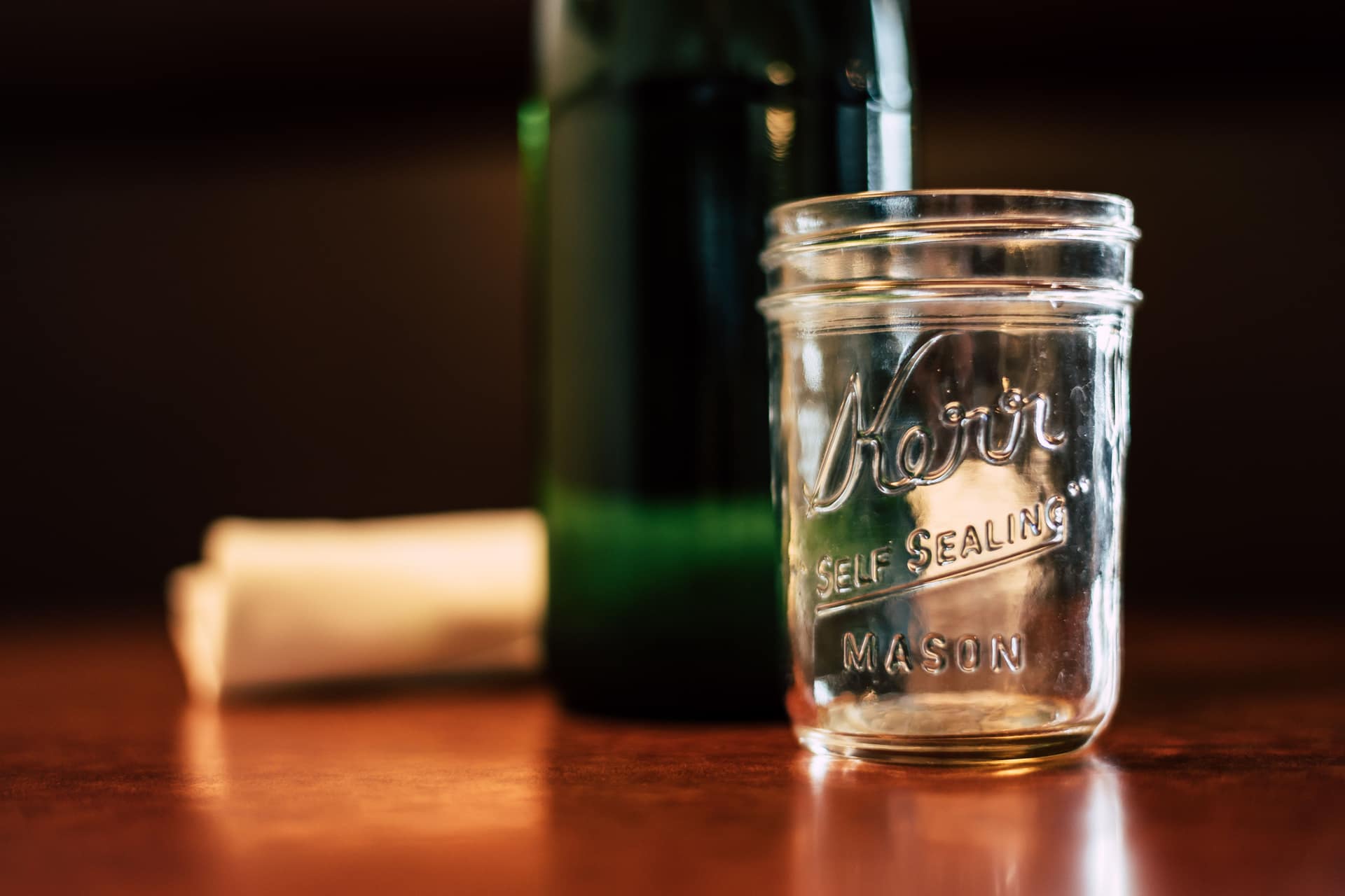 An empty Kerr mason jar on a wooden table