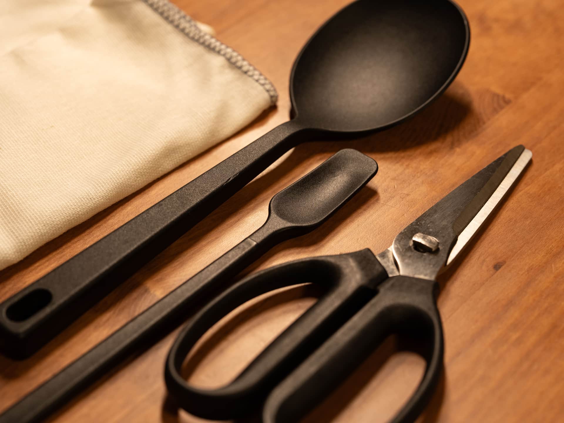 Kitchen utensils arranged on a dark wooden surface